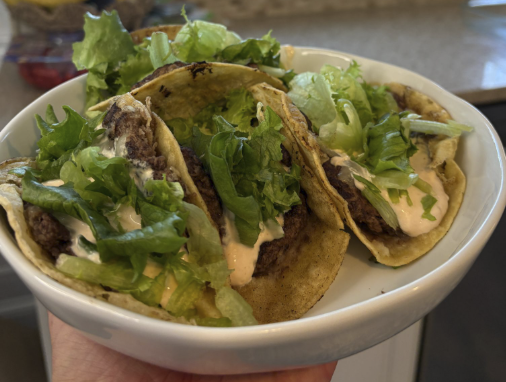 Beef tacos with lettuce and chipotle sauce
